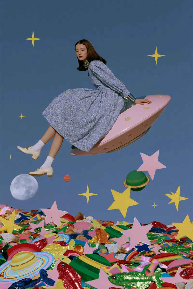 Surreal scene of a woman in vintage dress sitting on a pink flying saucer over colorful planets and stars