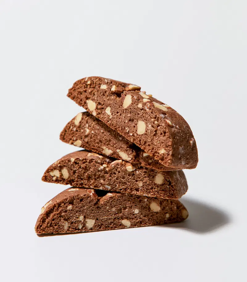 Close-up view of stacked chocolate biscotti with almond pieces