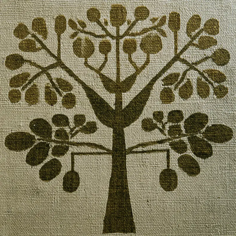 Stylized botanical illustration of a symmetrical leafy tree on textured fabric