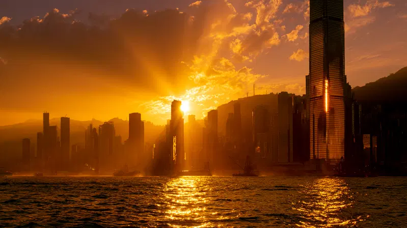 Golden sunset casting vibrant light over city skyline and water
