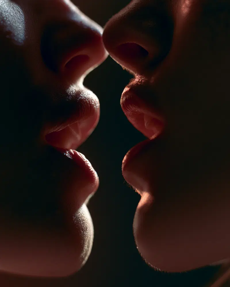 Close-up artistic portrait focusing on the intimate connection of two faces
