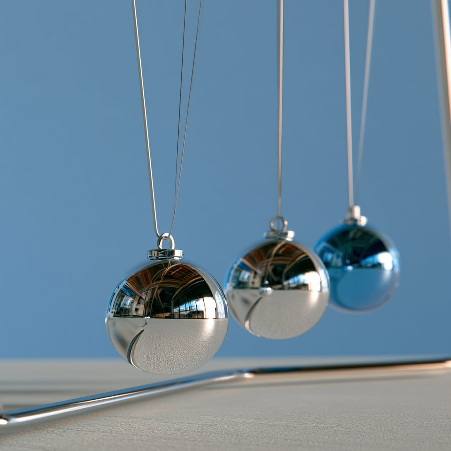 Close-up image of a Newton's Cradle with three silver reflective metal spheres suspended by thin wires against a plain blue background