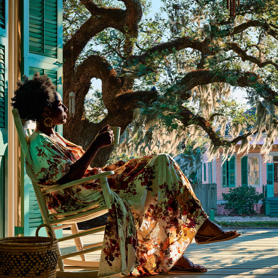A woman sitting on a rocking chair on a wooden porch holding a cup, with a large tree and houses in the background, bathed in warm sunlight.