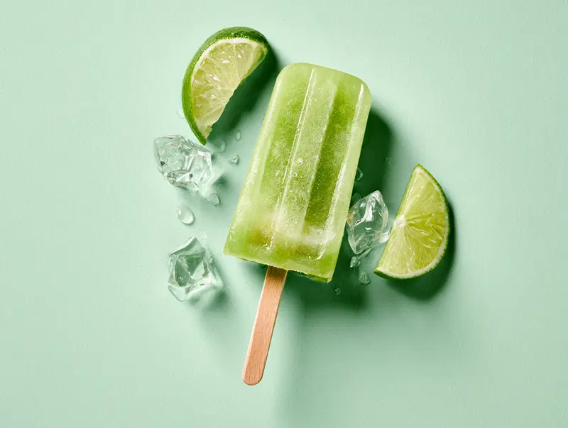 Realistic illustration of a lime popsicle with ice cubes and lime slices