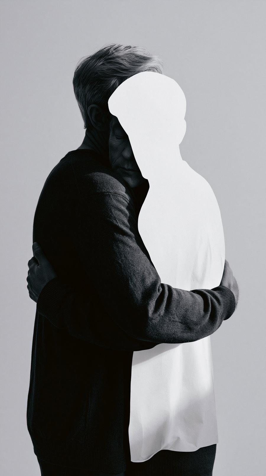 Black and white image of a man embracing a white silhouette figure with no face, creating a stark contrast
