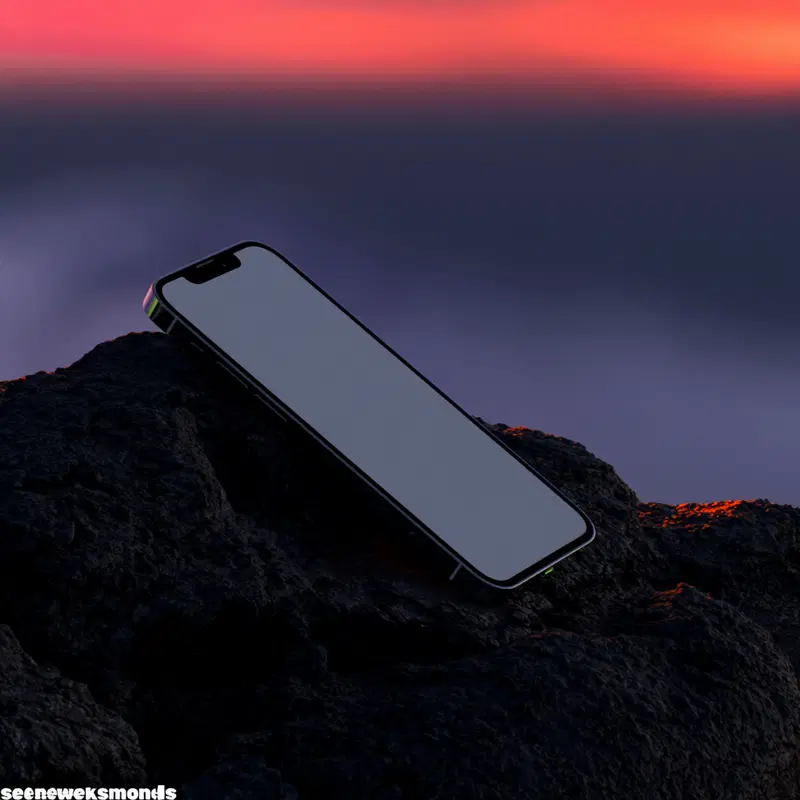 Smartphone with blank screen resting on dark rocky surface at sunset