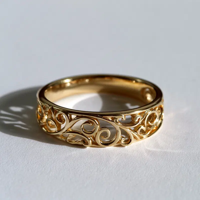 Close-up of an ornamental gold ring with elegant filigree design
