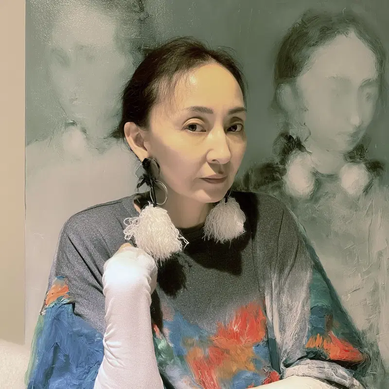 Artistic portrait of a woman posing in front of abstract painted figures