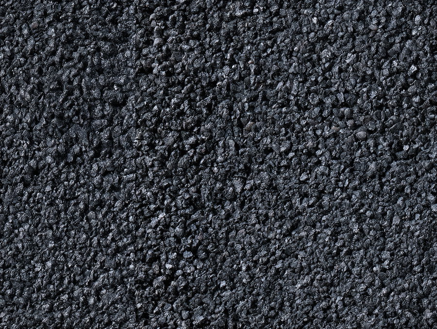 A detailed close-up image showing a rough surface covered with small black pebble-like textures evenly spread across the frame