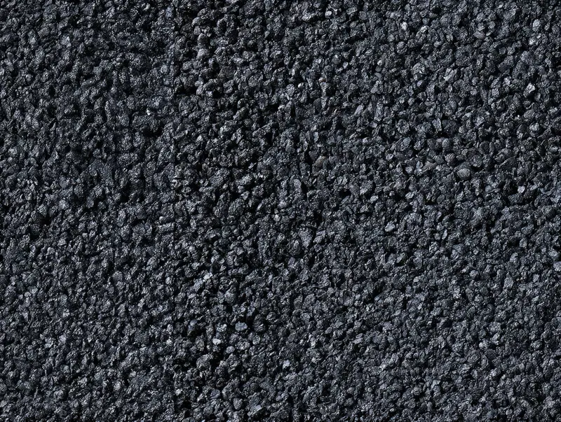 Close-up textured abstract art resembling rough black pebbled surface
