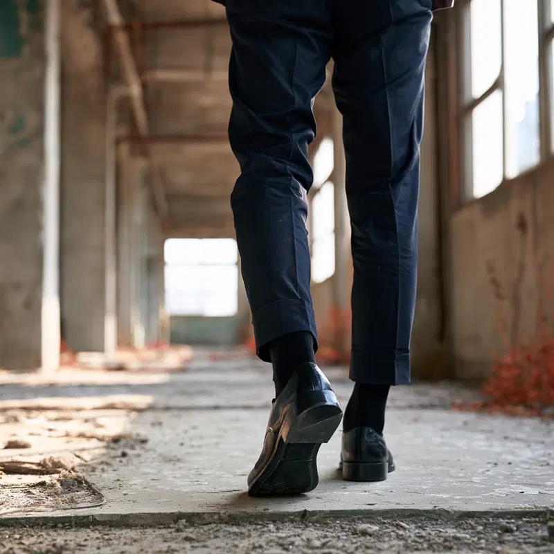Close-up artistic perspective of a person walking in an empty building