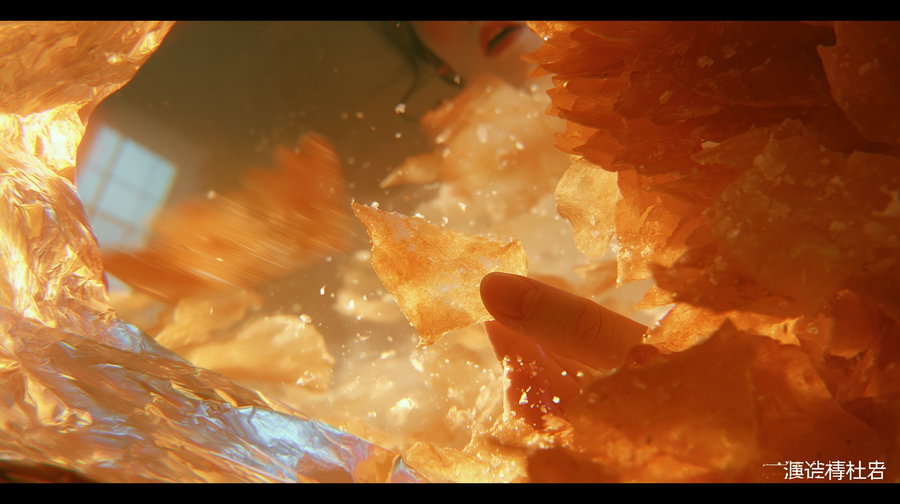 Close-up image showing a hand holding an orange translucent flake surrounded by many similar flakes inside a crinkled foil wrapping