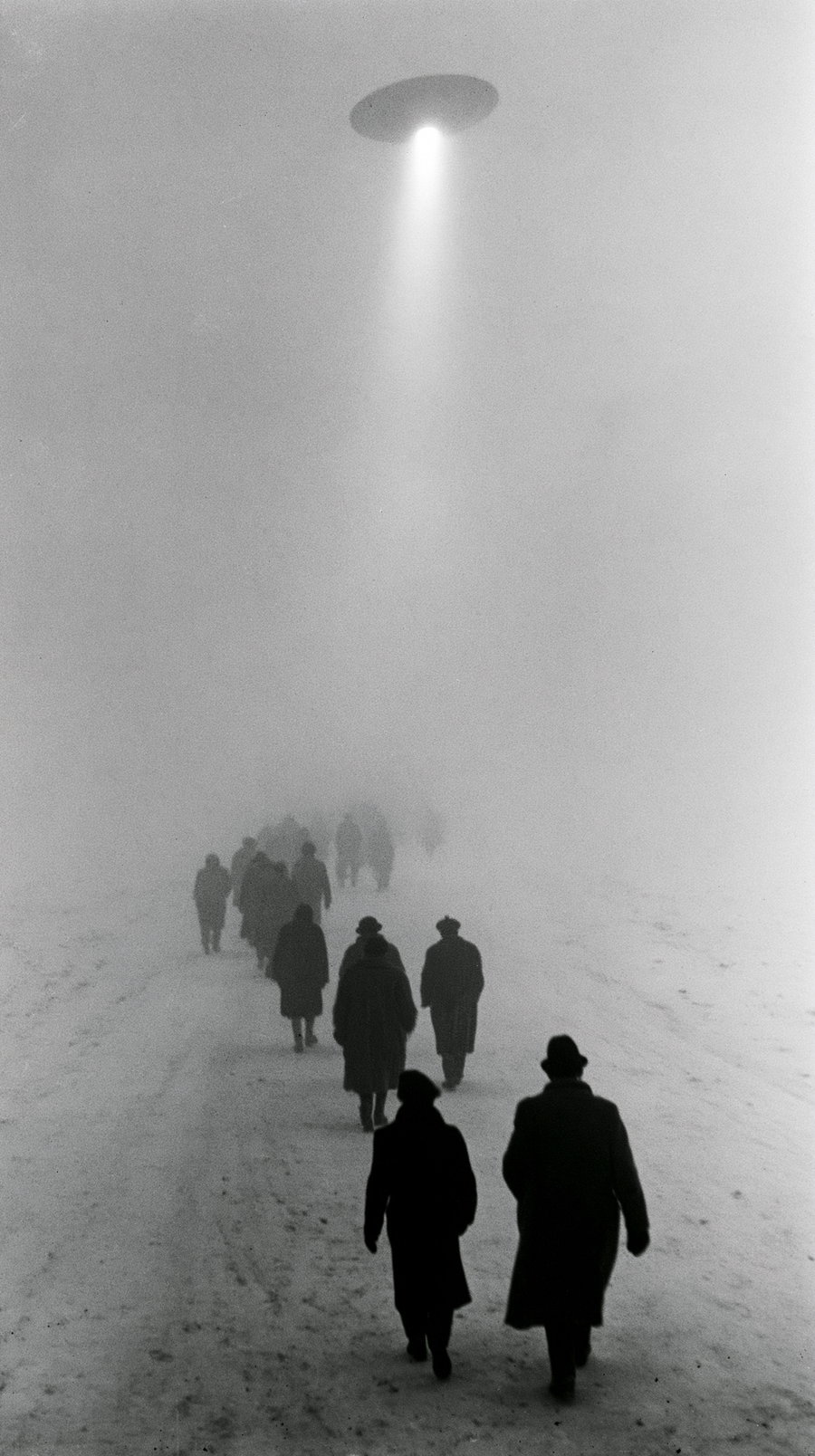 A group of people walking along a foggy path illuminated by a bright light beam from a circular object above.