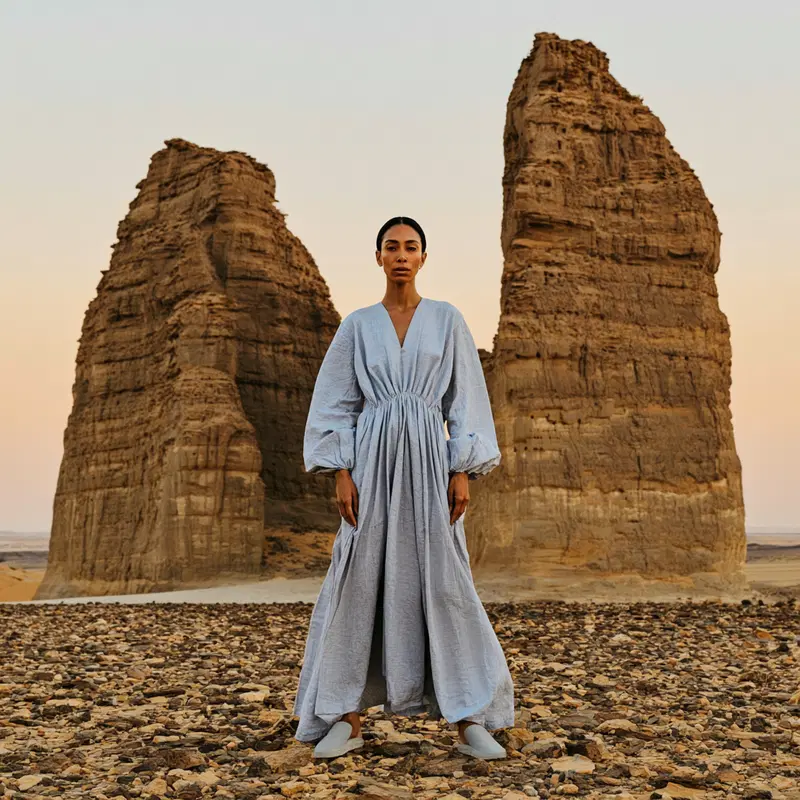 Woman standing in rocky desert landscape with natural rock formations