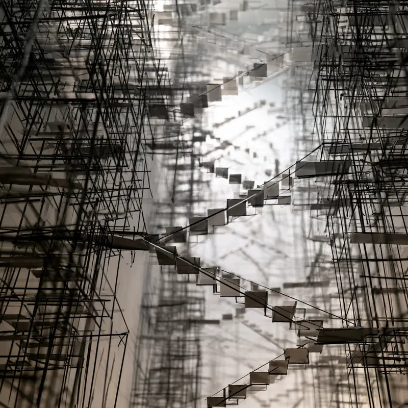 Intricate abstract installation with geometric wireframe structures and suspended elements