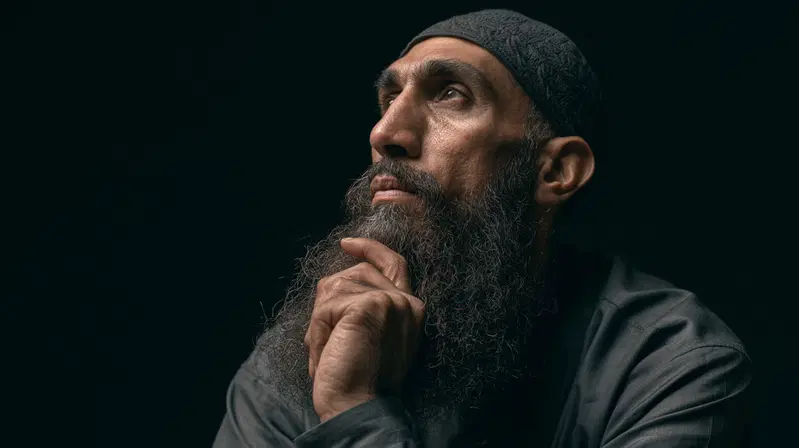 Contemplative bearded man looking upwards with thoughtful expression
