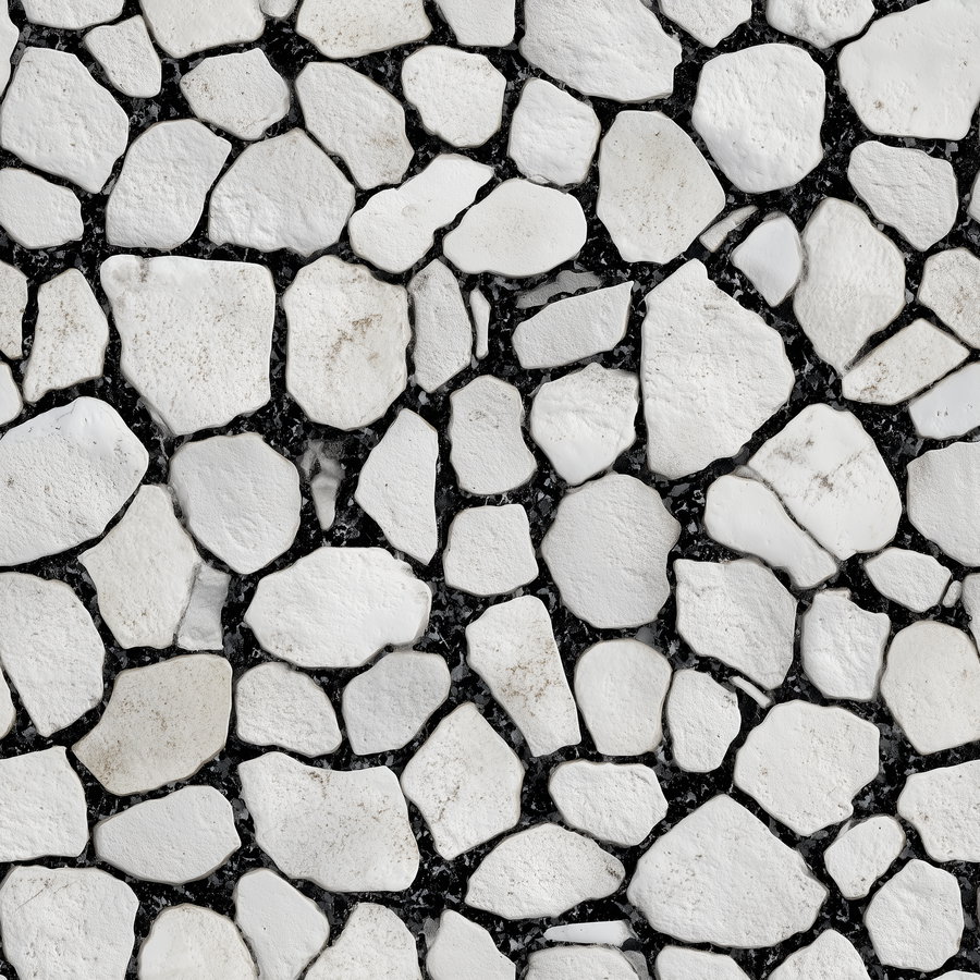 White irregular stones set in black grout forming a textured pattern