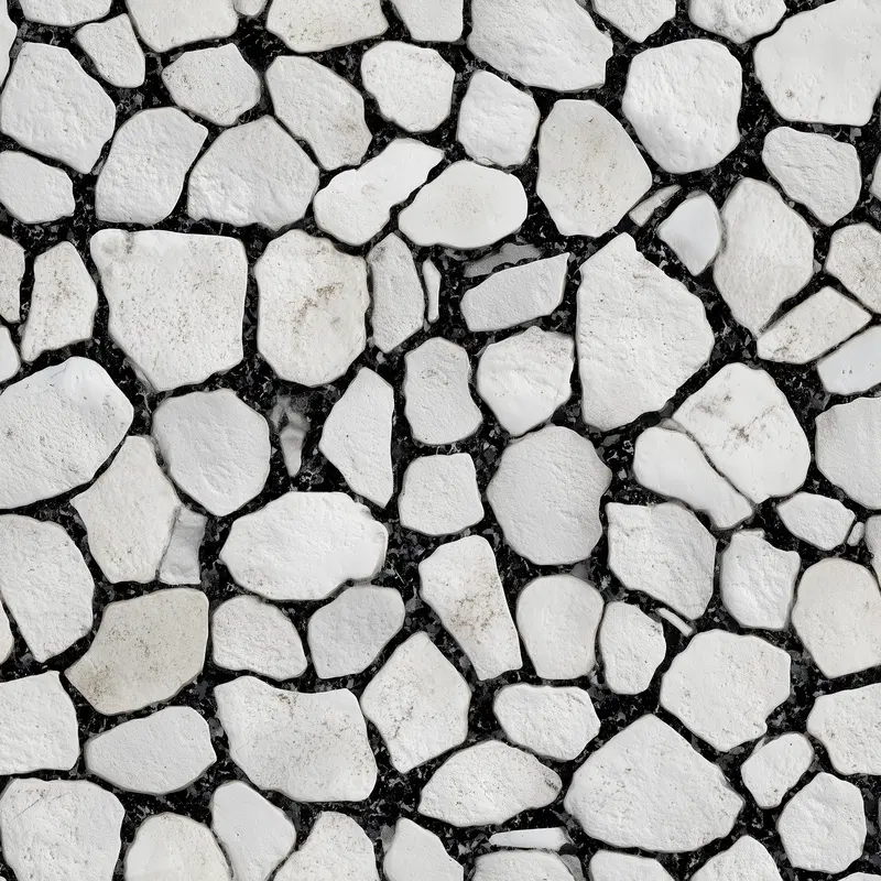 Close-up of white stones embedded in black grout for neutral wall decor
