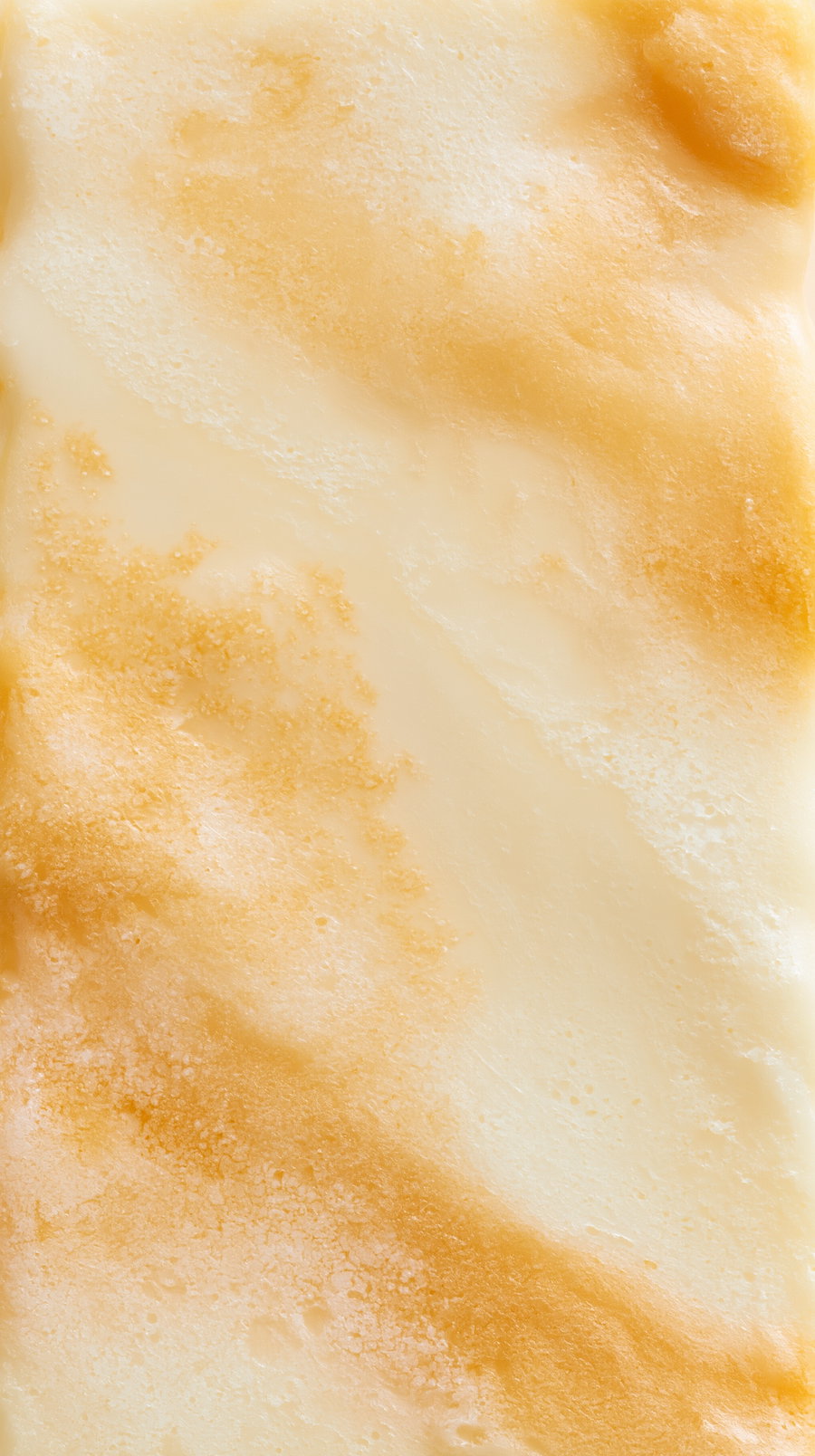 A smooth surface featuring blended warm earth tones including beige, cream, and light brown with a soft marbled texture.