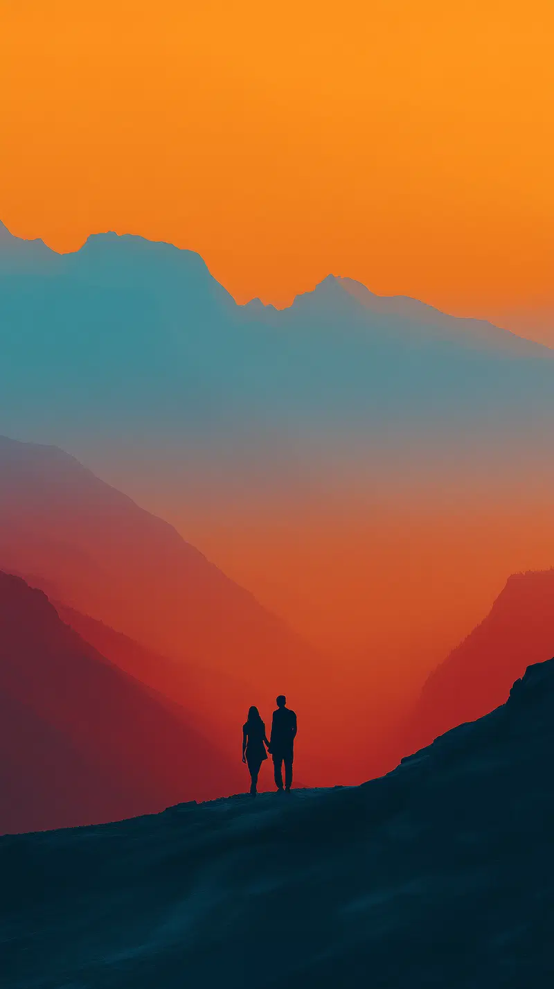 Silhouetted couple holding hands with a dramatic sunset over misty mountains