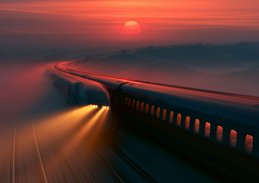 A high-speed train with illuminated headlights traveling on curved tracks through misty mountains at sunset, with a large red sun and mountainous landscape in the background.