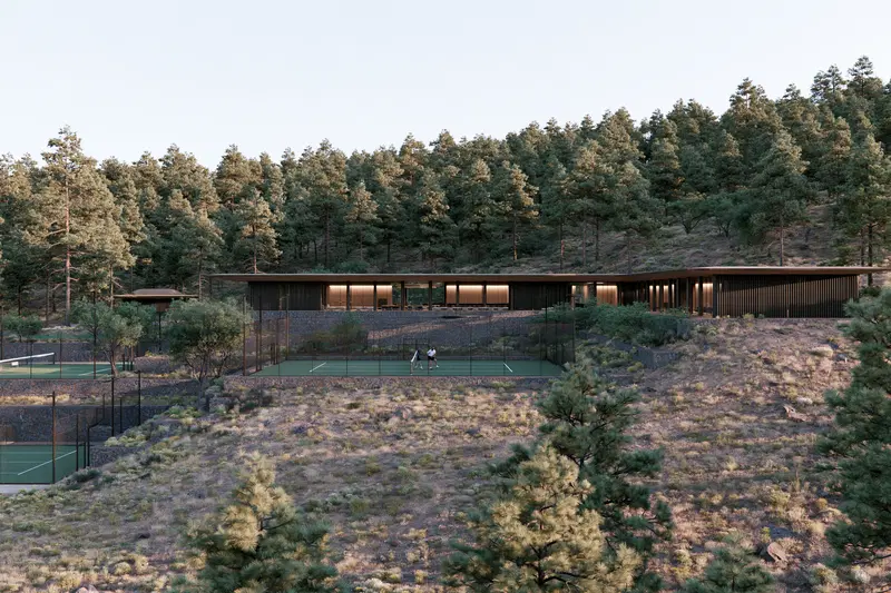 Modern Home with Tennis Courts Surrounded by Pine Trees on a Hillside