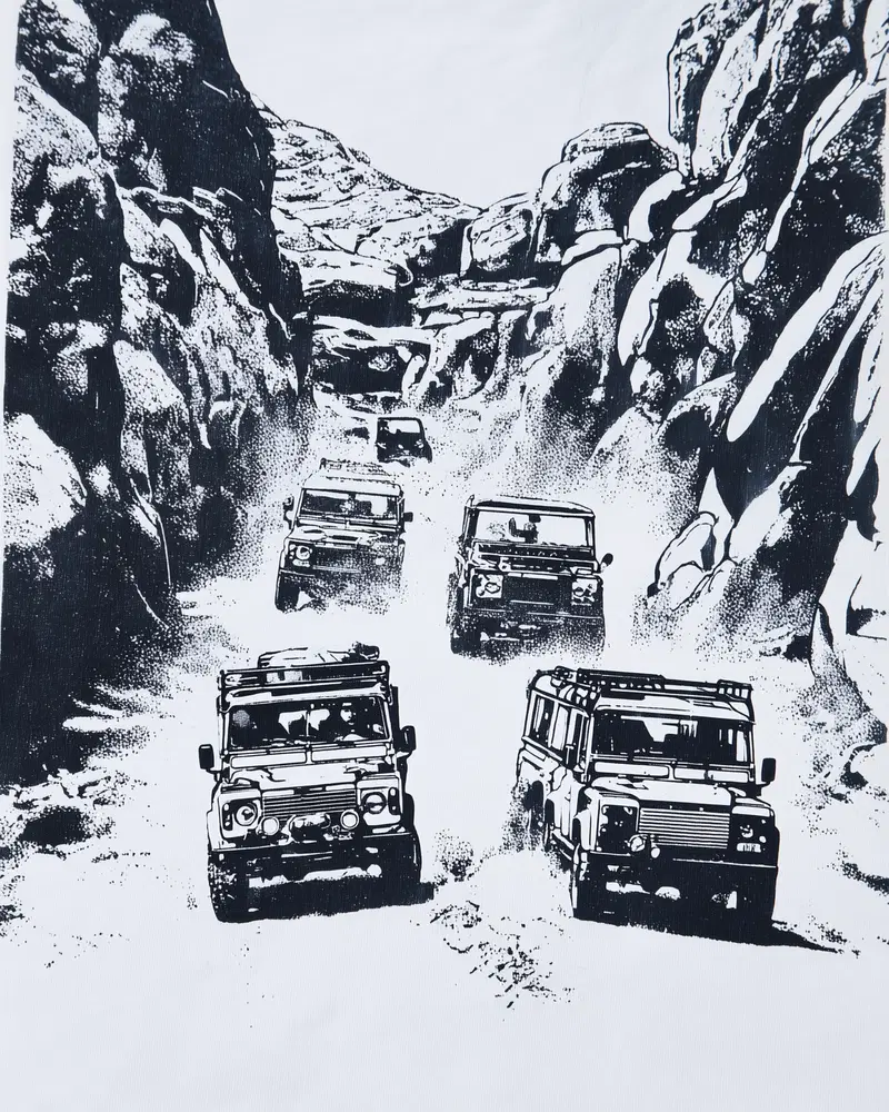 Black and white illustration of off-road vehicles driving through rocky terrain