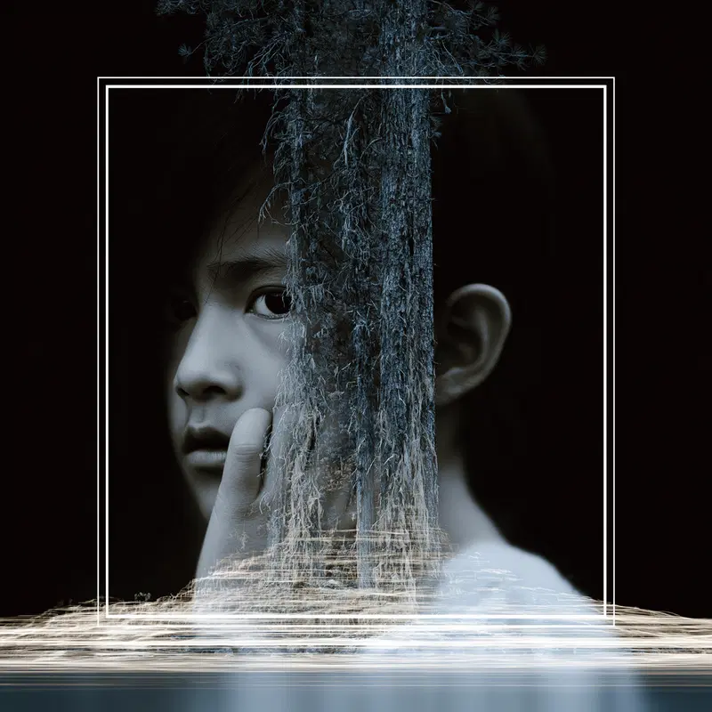 Fine art portrait blending a child's face with textured natural elements in monochrome tones