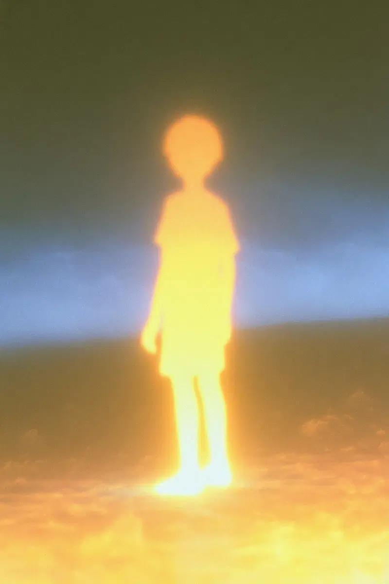 Glowing silhouette of a child standing with blurred and ethereal lighting