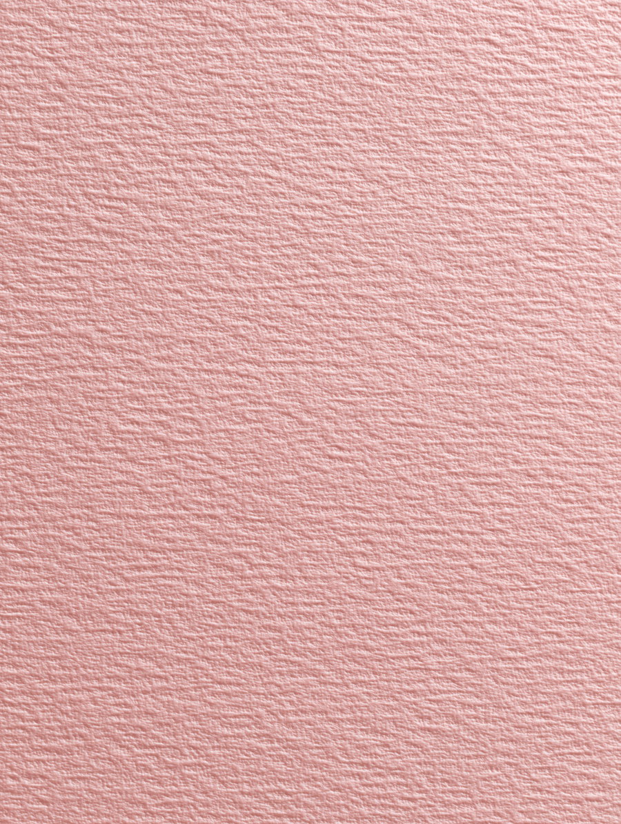 Close-up image of a soft pink textured wall or paper surface