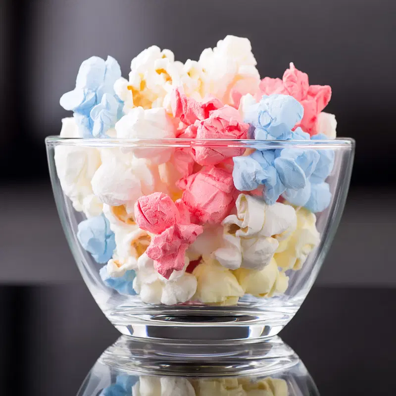 Vibrant colored popcorn in clear glass bowl showcasing colorful texture and tones