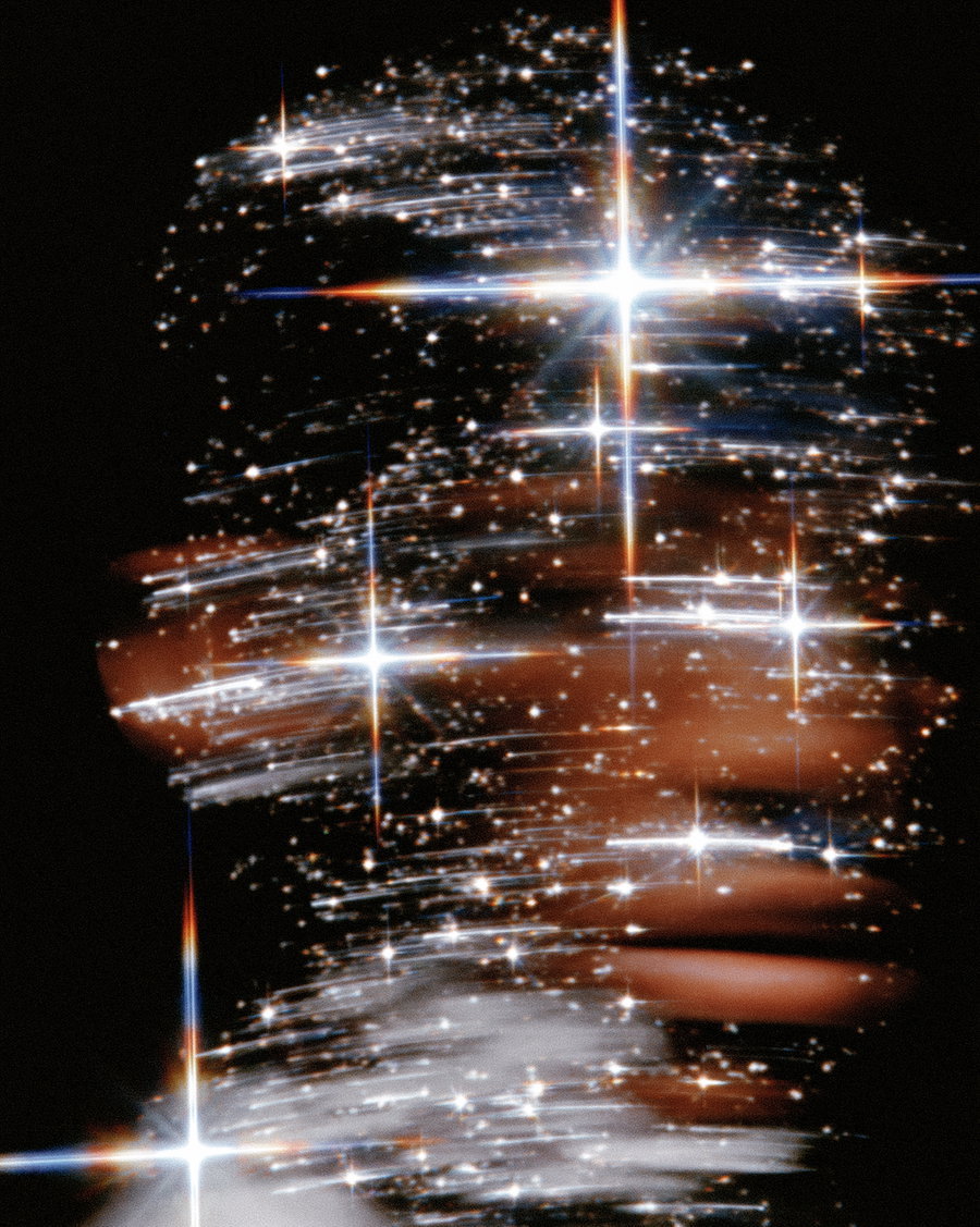 Close-up of a person obscured by abstract swirling sparkles and bright light flares on a dark background
