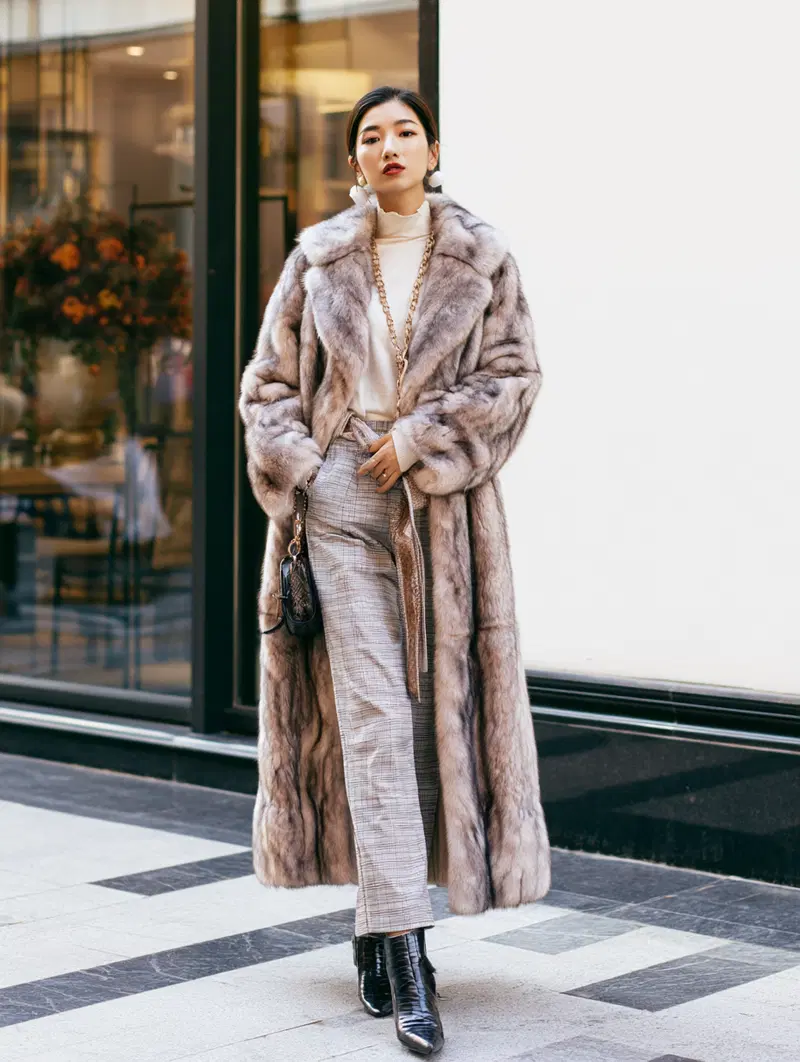 Elegant fashion photograph showcasing luxurious winter outfit with fur coat