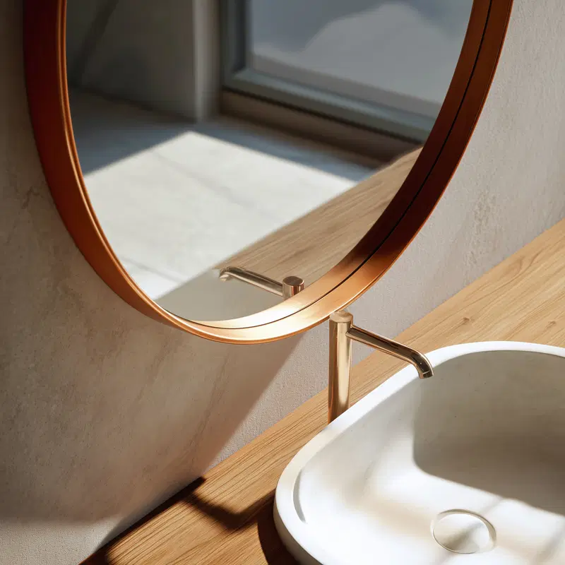 Minimalist bathroom decor with round mirror and modern faucet over sink