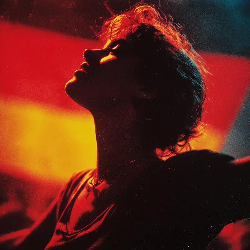 Dramatic red and orange toned portrait of a person with backlit hair