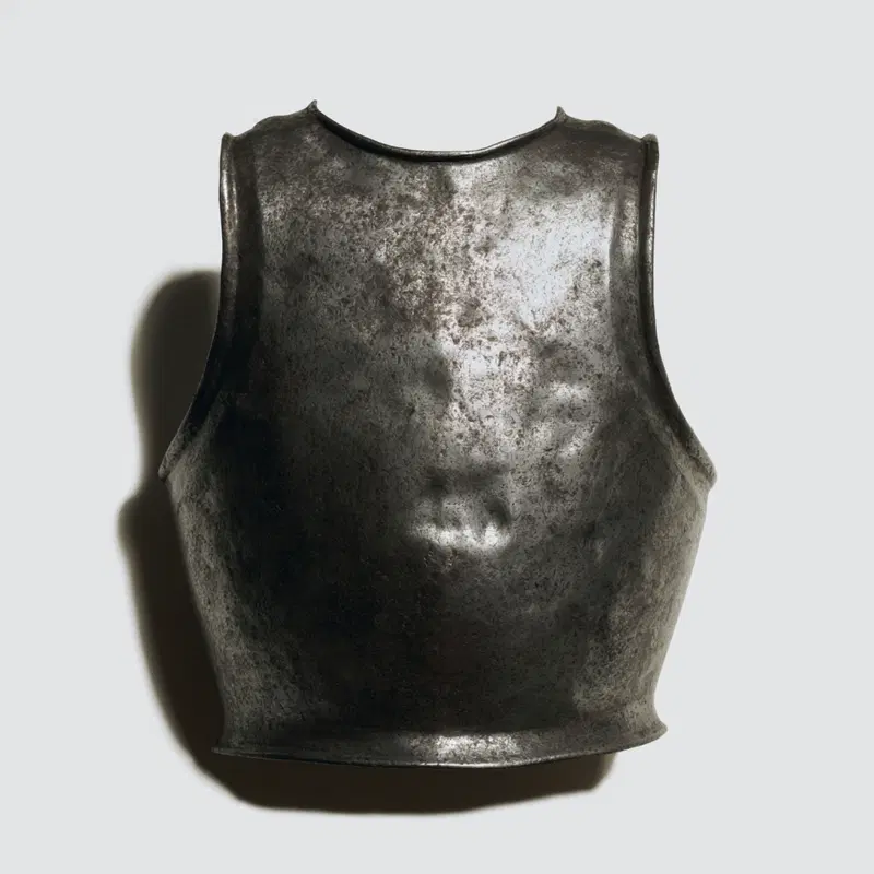 Antique medieval breastplate armor displayed on a neutral background