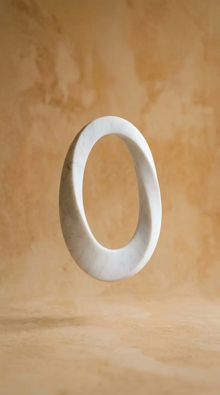 Minimalist marble sculpture with abstract oval shape on neutral background