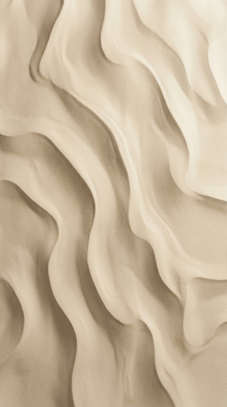Close-up image showing smooth, flowing curves and ridges in beige sand resembling natural sand dunes