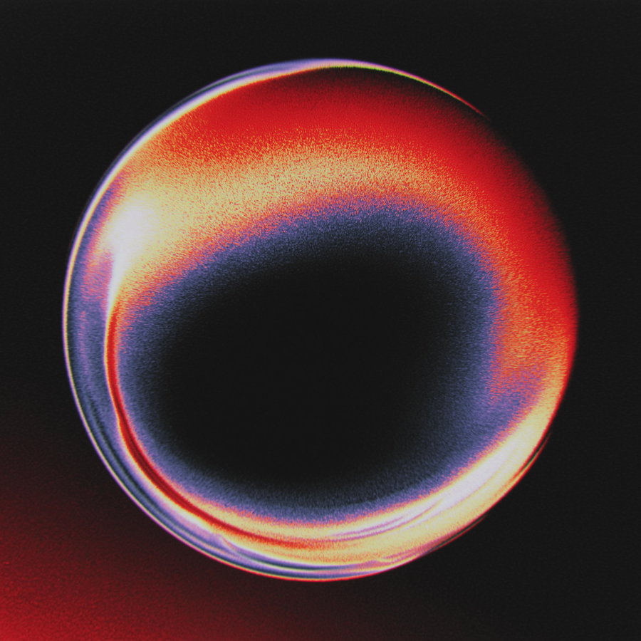 Abstract circular shape with gradient colors from red to blue on black background
