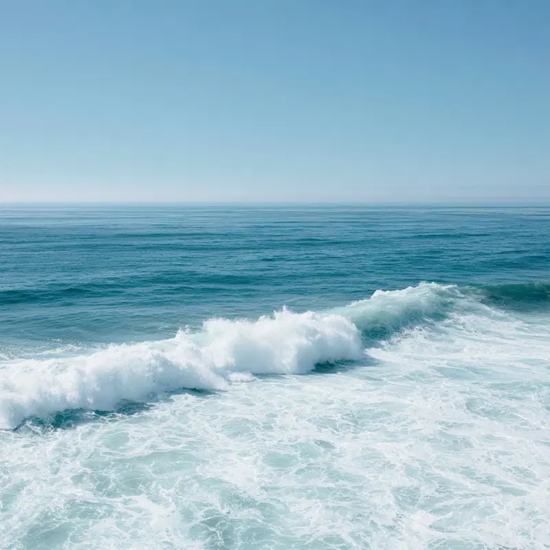 Serene ocean waves rolling under a clear blue sky over the sea