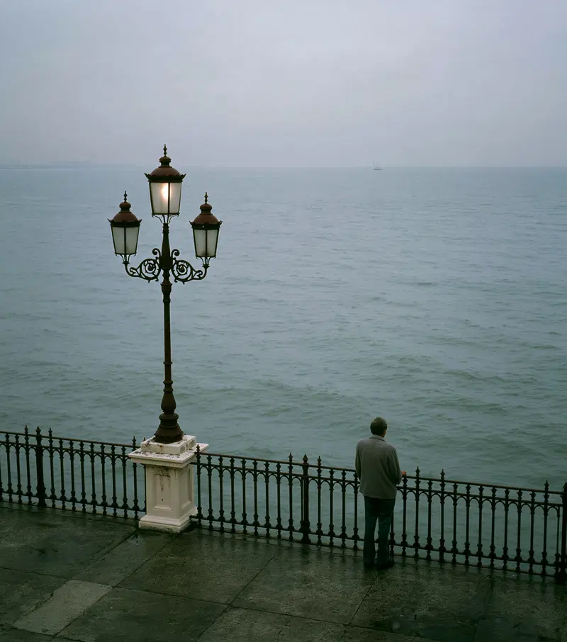 A Man Reflecting by the Sea in a Liminal Space