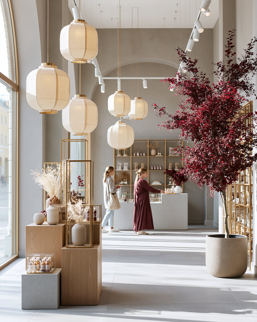 A sophisticated boutique interior featuring elegant lighting, a shopper engaging with a display, warm materials, and ample negative space.