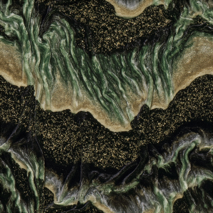 Detailed close-up of crushed emerald velvet with light and dark green organic patterns.