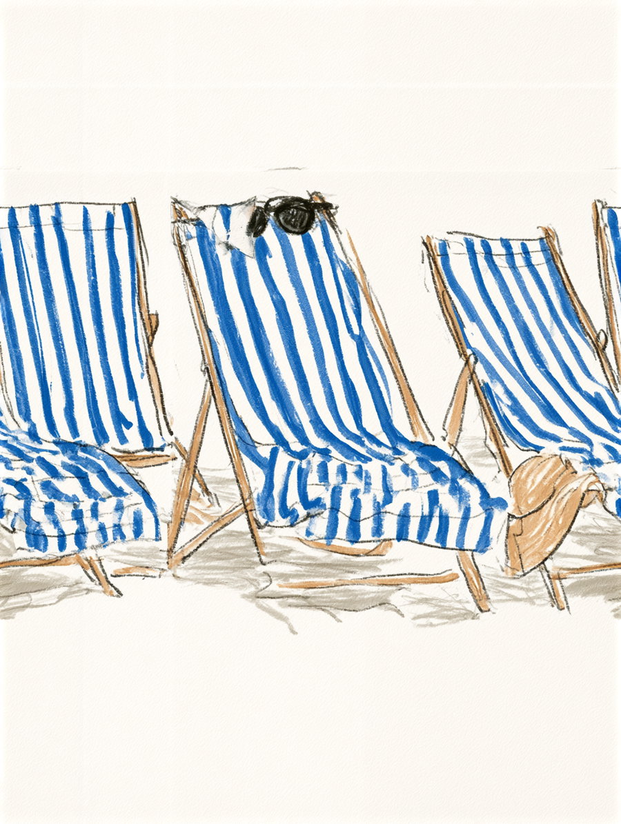 A row of blue and white striped deck chairs on a sandy beach, with some accessories like sunglasses on one of the chairs.