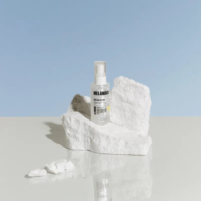 Serum Product Showcase on Marble with Clear Blue Sky Background