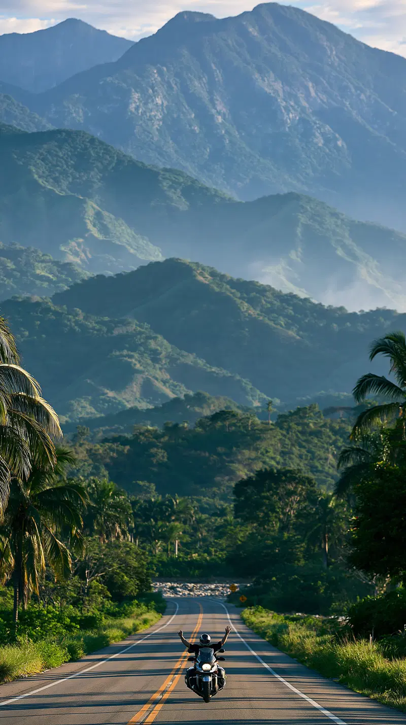 Rider on Motorcycle with Mountains and Tropical Vegetation