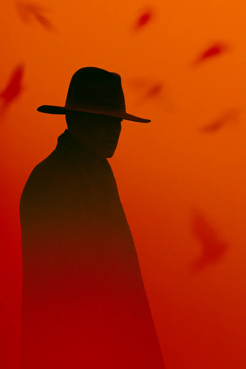 Silhouette of a Cowboy Against a Dramatic Orange Background