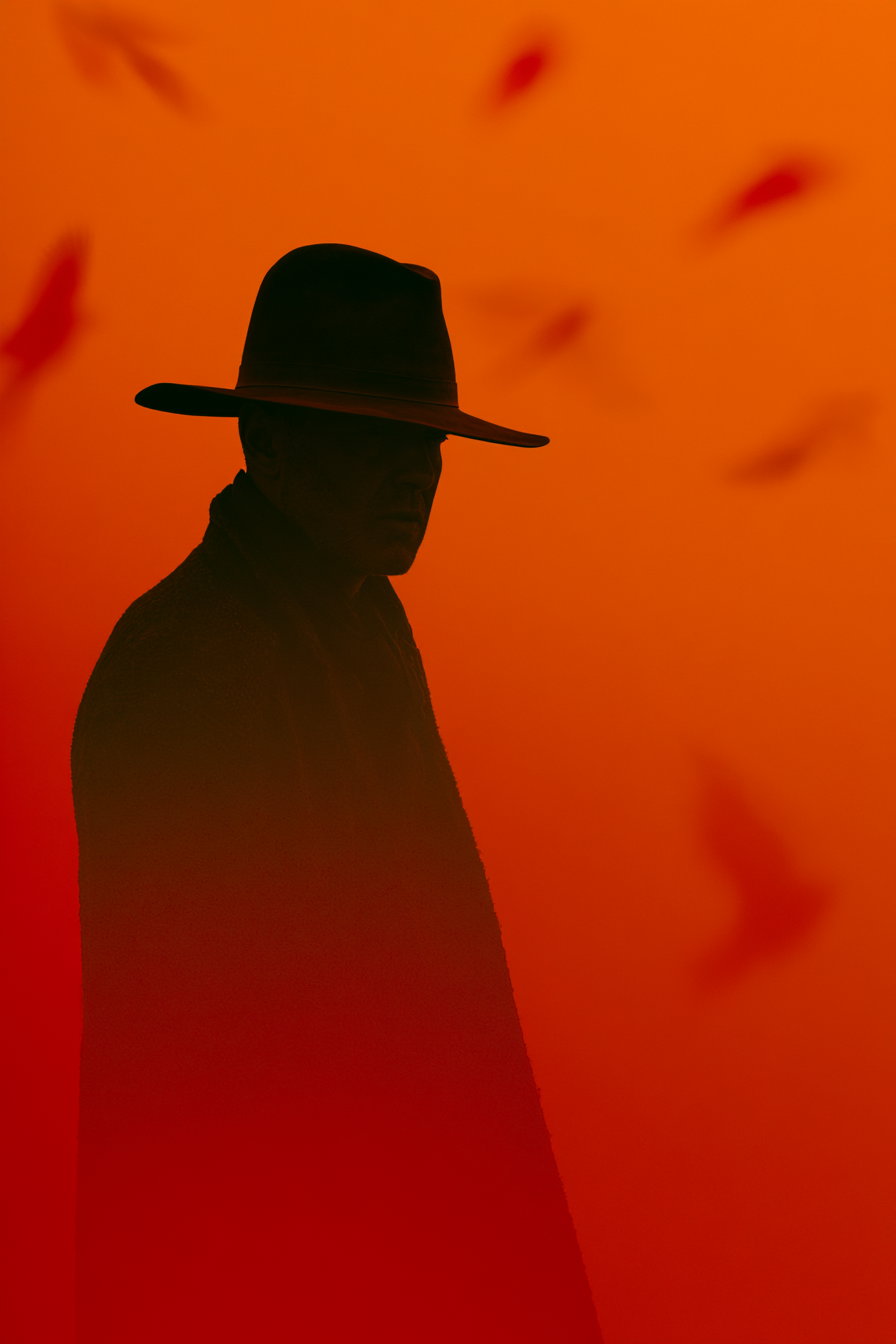 A dark silhouette of a cowboy wearing a wide-brimmed hat, set against a vibrant orange and red gradient background with hints of birds in motion.